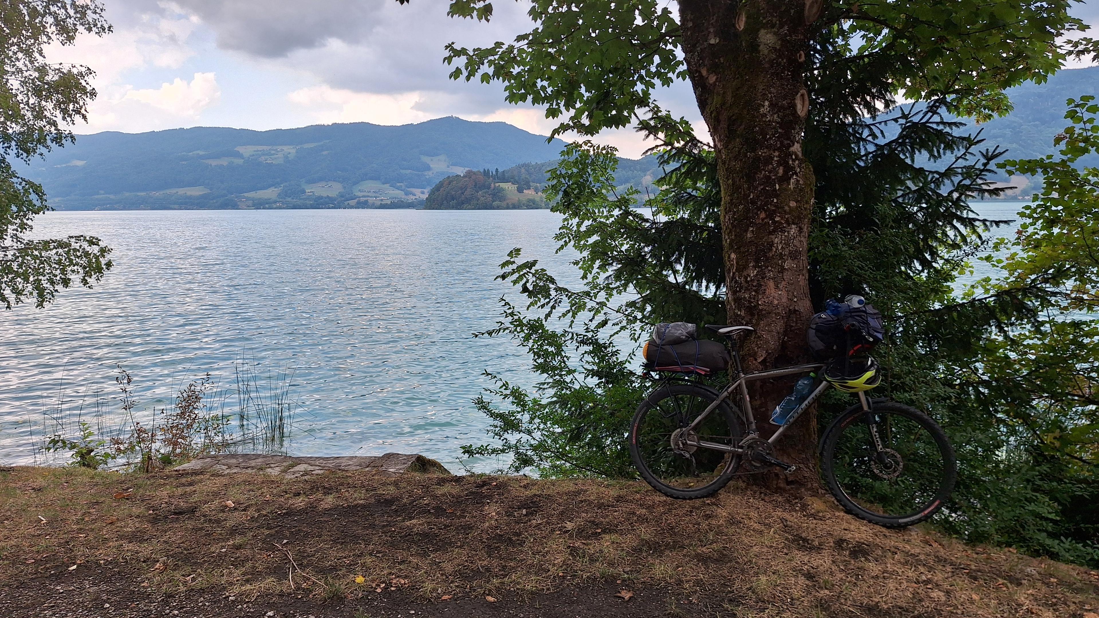 Trekové kolo na březích Mondsee. K hladině vedou schody, ale auta zde nesmějí zastavit a na vstup do vody není vidět.